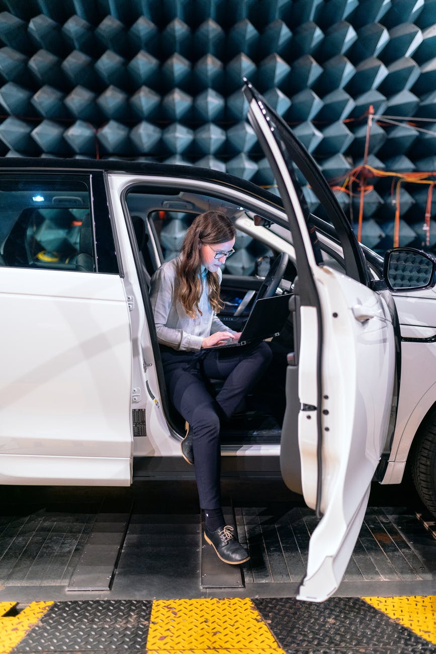 photo of female engineer sitting inside a car