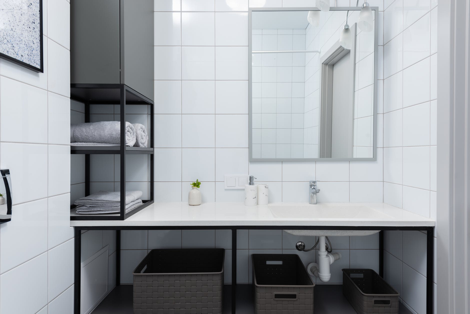 modern bathroom interior with counter near mirror and shelves